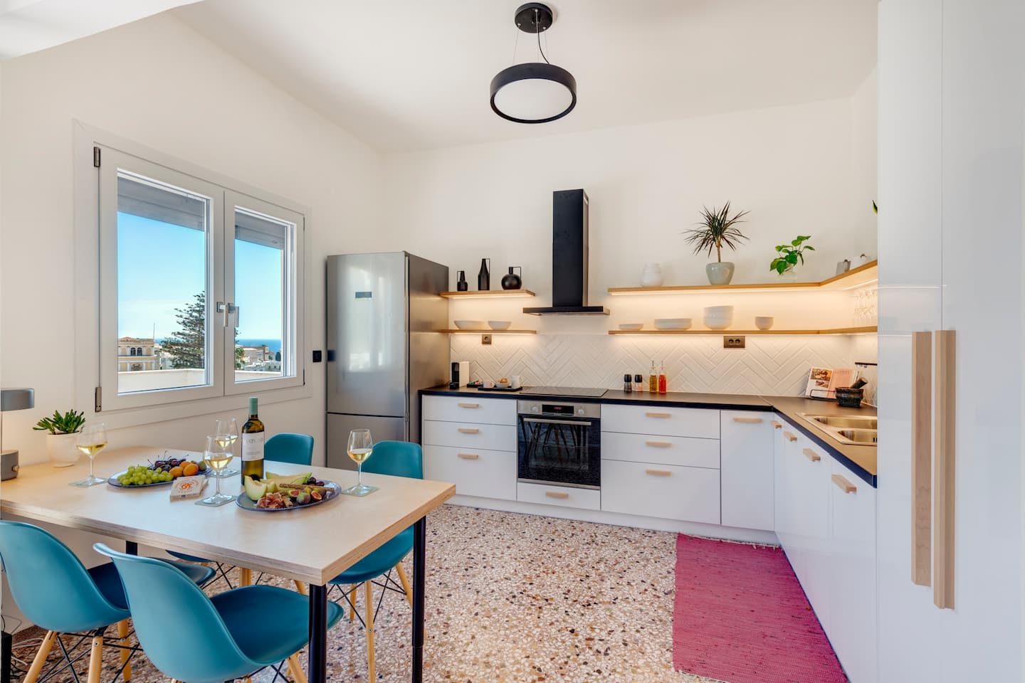 Open kitchen and dining area with sea view through the window